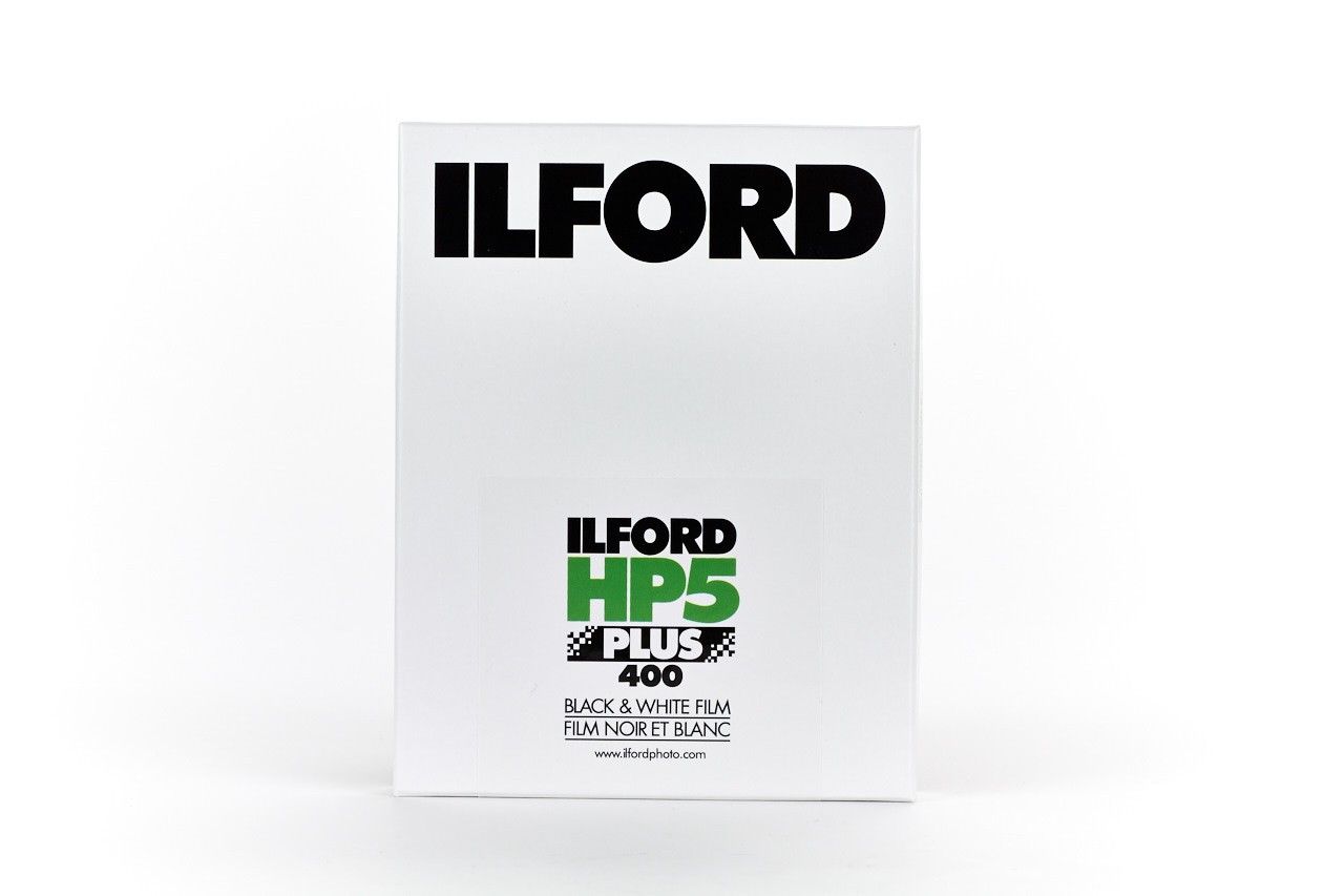 An Ilford HP5 Plus 400 black and white film on a white background. 4x5", 25 Sheets.
