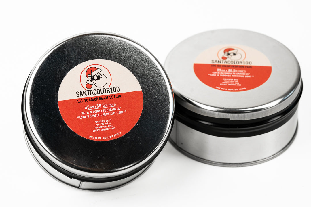 A close-up of two SantaColor 100 bulk rolls on a white background. For 35mm cameras. 30m/100ft