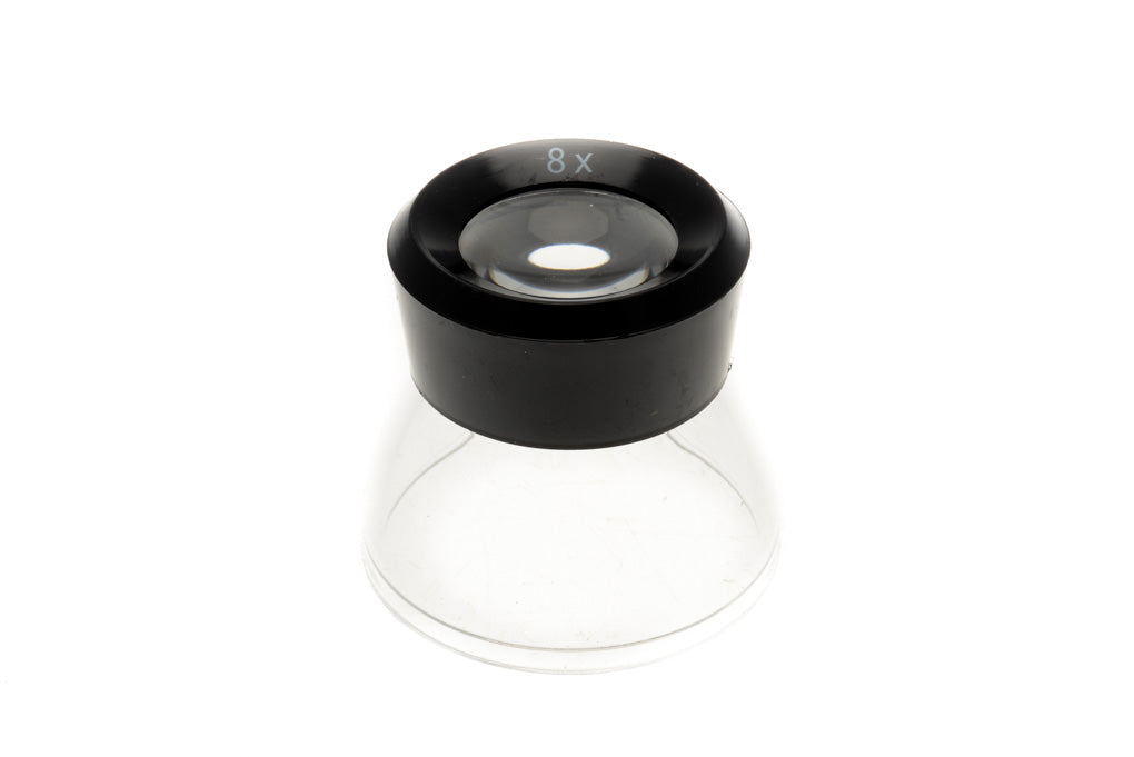 A plastic 8x loupe for viewing negatives or slides in darkroom.