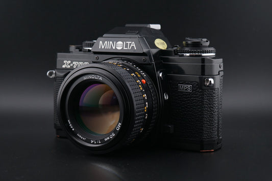 Black Minolta X-700 film camera on a black background