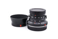 7Artisans 28mm lens with a lens cap on a white background.