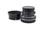 7Artisans 28mm lens with a lens cap on a white background.