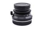 7Artisans 28mm lens with a lens cap on a white background.