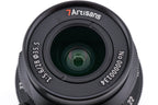 A close-up of a 7Artisans 28mm lens front on a white background.