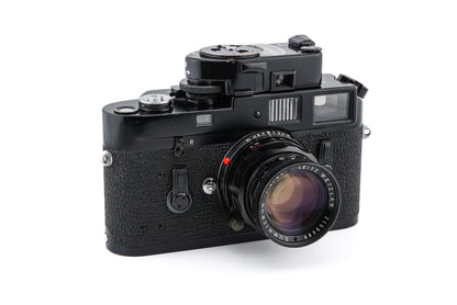 Front left view of an original black paint leica M4 with matching 50mm lens and meter