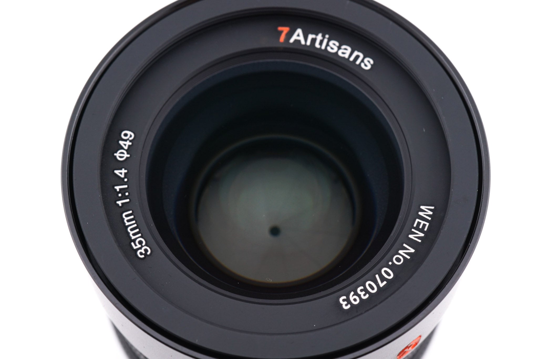A close-up of an 7Artisans 35mm f1.4 lens front on a white background.