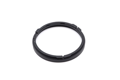 Black filter adapter ring for Hasselblad bayonet, photographed from behind against a white background.