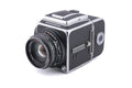 Hasselblad 500C/M (Silver, 10026) + 80mm f2.8 Planar T* C (Black, 20028) + A12 Film Magazine (Silver, 30074) + Waist Level Finder (New / Chrome, 42315) + Lens Shade 80 (40118/SEMOC) + Acute Matte Focusing Screen (42165) + Checked Screen (42072/TILMC)