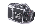 Hasselblad 500C/M (Silver, 10026) + 80mm f2.8 Planar T* C (Black, 20028) + A12 Film Magazine (Silver, 30074) + Waist Level Finder (New / Chrome, 42315) + Lens Shade 80 (40118/SEMOC) + Acute Matte Focusing Screen (42165) + Checked Screen (42072/TILMC)
