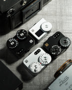 Several Doomo Meter D hot shoe light meters on a table surrounded with camera gear.  