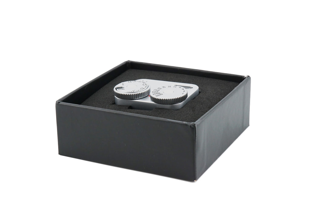 Doomo Meter D hot shoe chrome light meter in open box with white background.