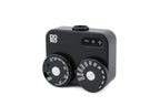 A black Doomo Meter D hot shoe light meter from the top with white background.