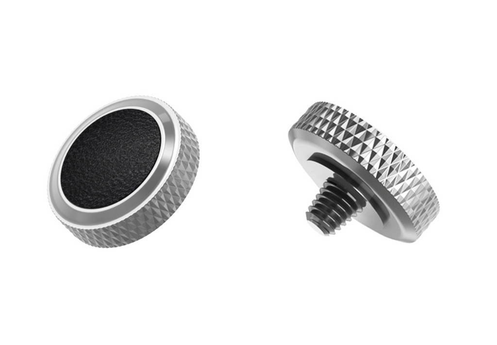 A close-up of JJC Deluxe soft release button from the front and side on a white background. Silver black color.  