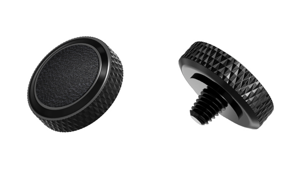A close-up of JJC Deluxe soft release button from the front and side on a white background. Black color.  