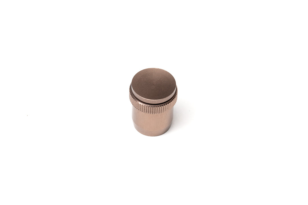 A bronze soft release button on a white background. For Nikon AR-1.