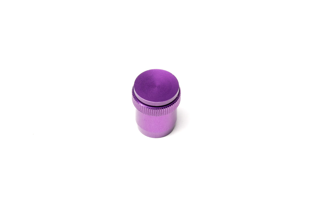 A purple soft release button on a white background. For Nikon AR-1.