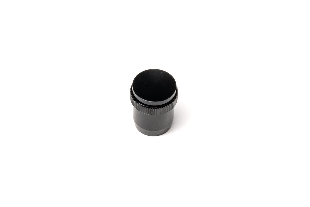 A black soft release button on a white background. For Nikon AR-1.