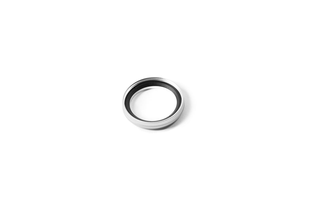 A close-up of 37mm metal adapter on a white background.  