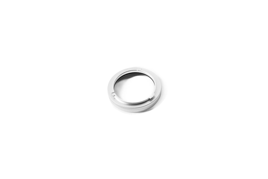 A close-up of 37mm metal adapter on a white background.  
