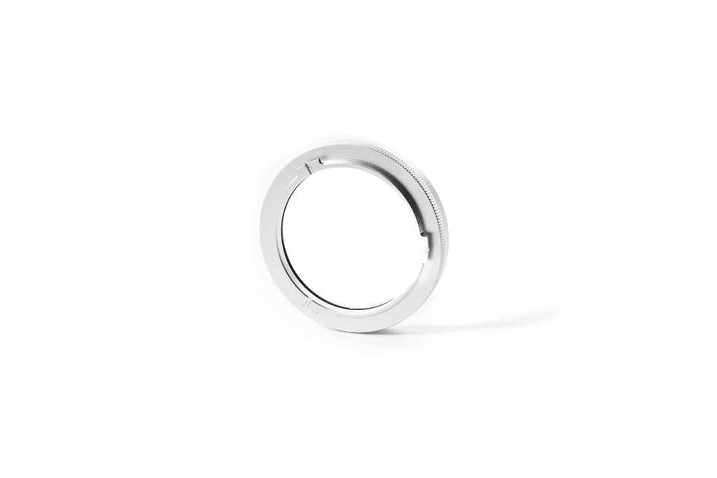 A close-up of 37mm metal adapter on a white background.  