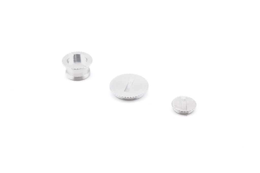 A close-up of aftermarket coupler / socket cover set on a white background. For Canon New F-1.