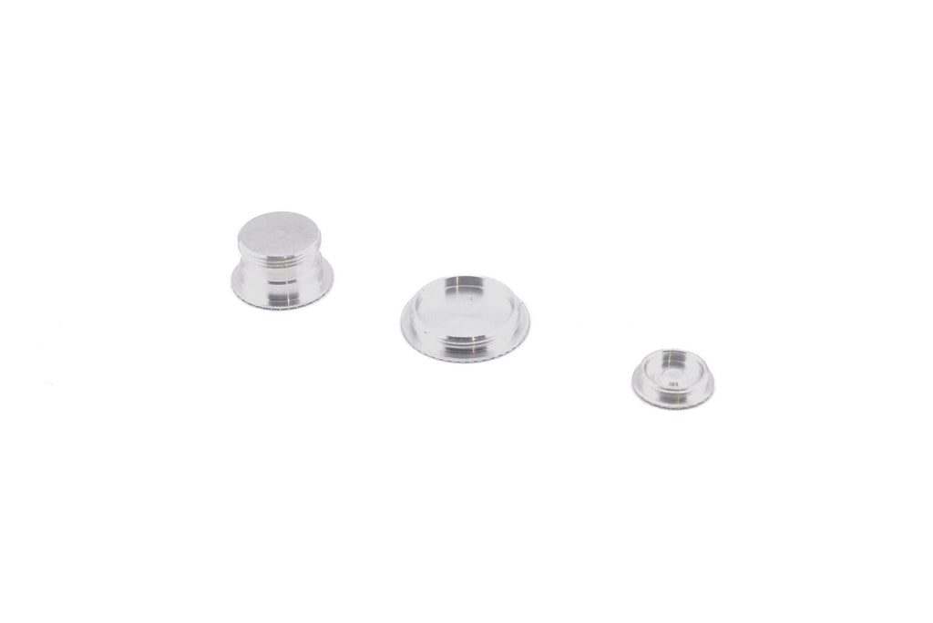 A close-up of aftermarket coupler / socket cover set bottomside on a white background. For Canon New F-1.