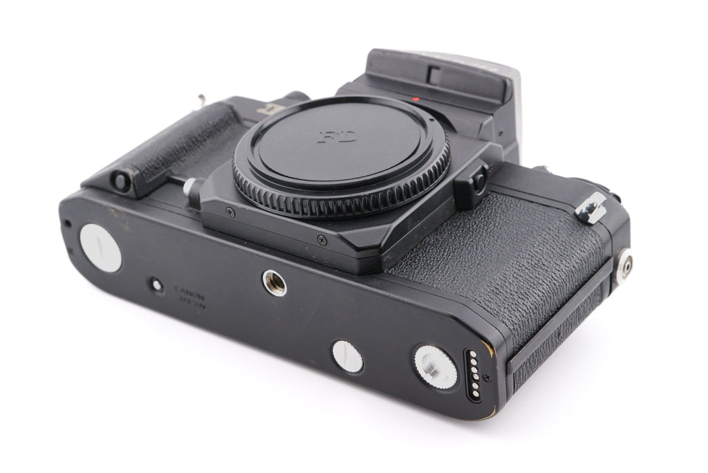 A close-up of aftermarket coupler / socket cover set installed on a camera body on a white background. For Canon New F-1.