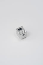 The KMQ chrome top display model from afar on a white background.