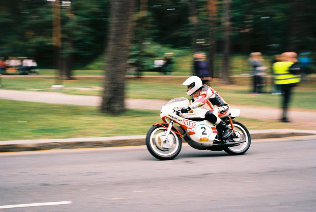 A blurred photo of a fast-driving motorcycle. 