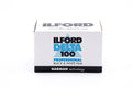 Ilford Delta 100 Professional ISO 100 black and white film package on a white background. 35mm film.