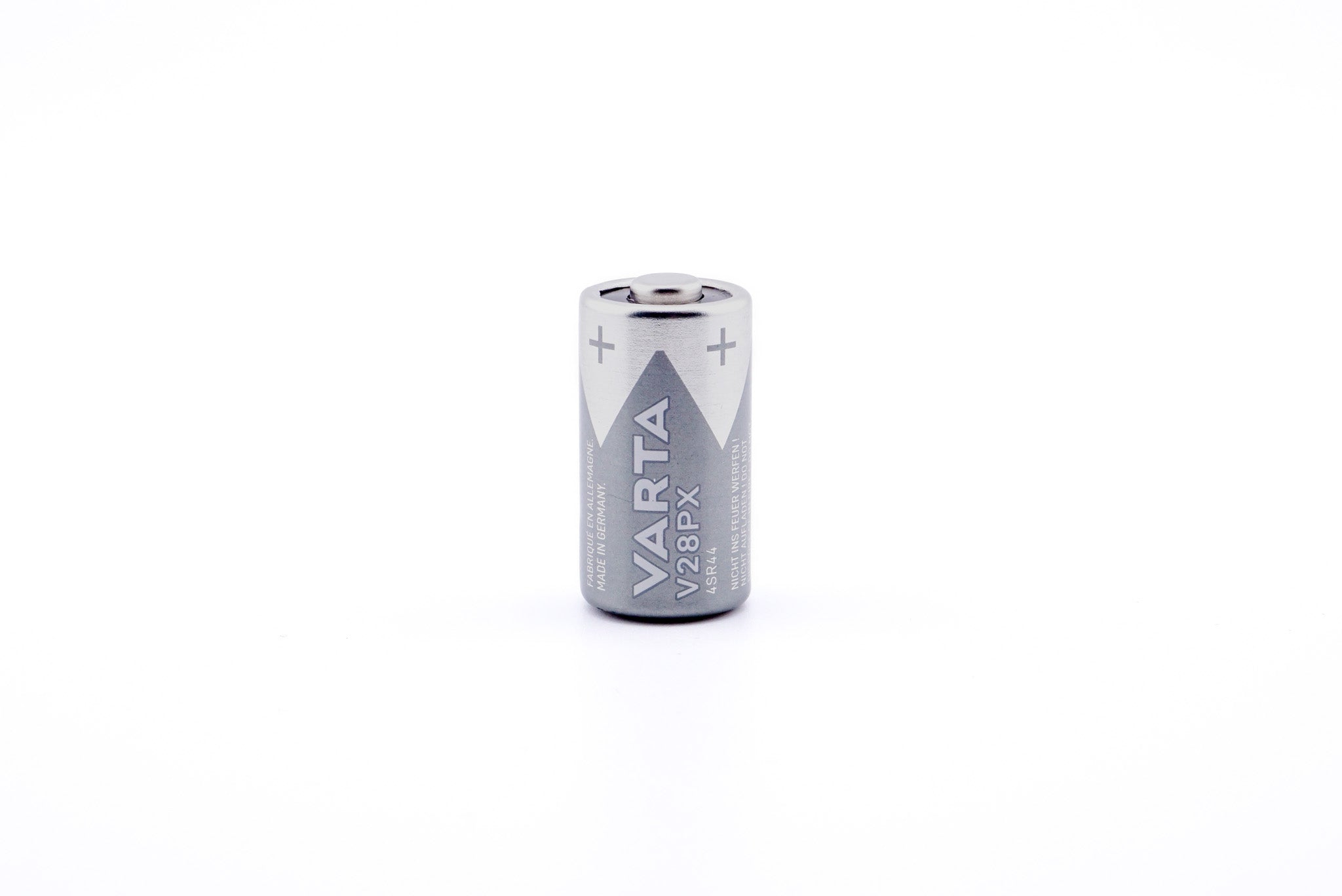 A battery on a white background. A battery in a package on a white background. Varta 4SR44 6.2V.