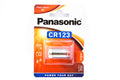 A battery in a package on a white background. Panasonic CR123A 3V.