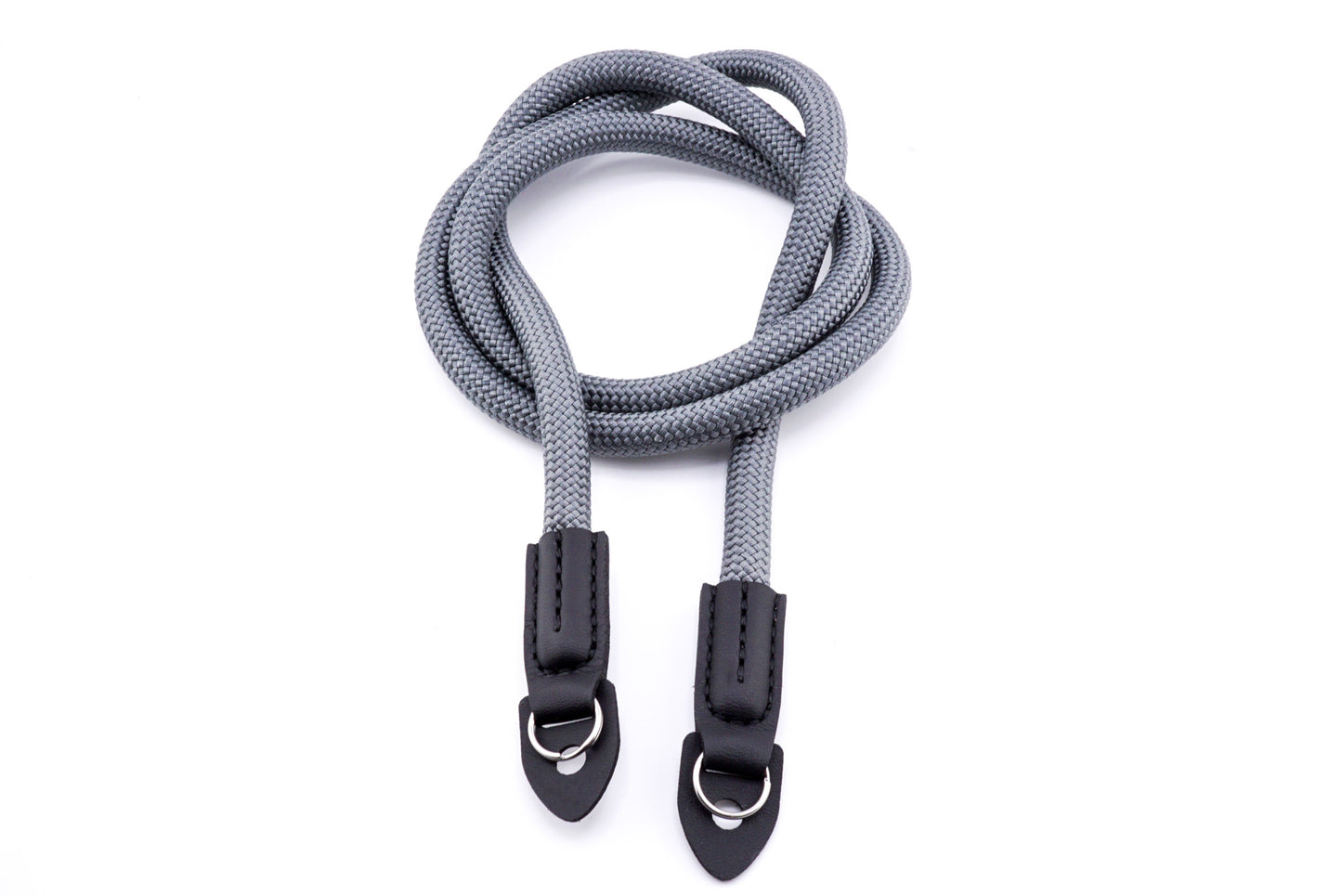 A grey rope camera strap on a white background.