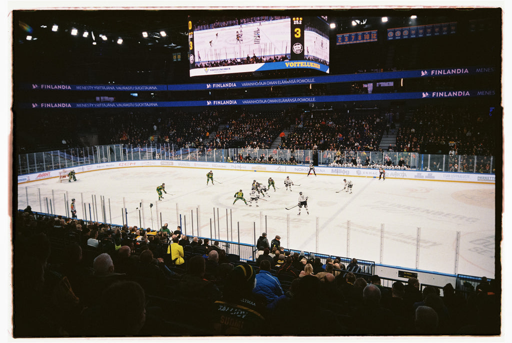 A hockey stadium with crowd, ice and a big screen. A Kodak Ultramax 400.