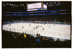 A hockey stadium with crowd, ice and a big screen. A Kodak Ultramax 400.