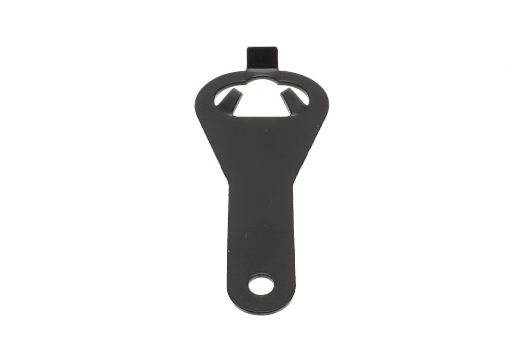 A metal film canister opener on a white background. For 35mm films.