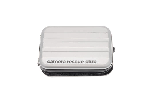 Camera Rescue Club case in silver. Size 120 x 85 x 40mm. Includes a carabiner for hanging from a strap or bag.