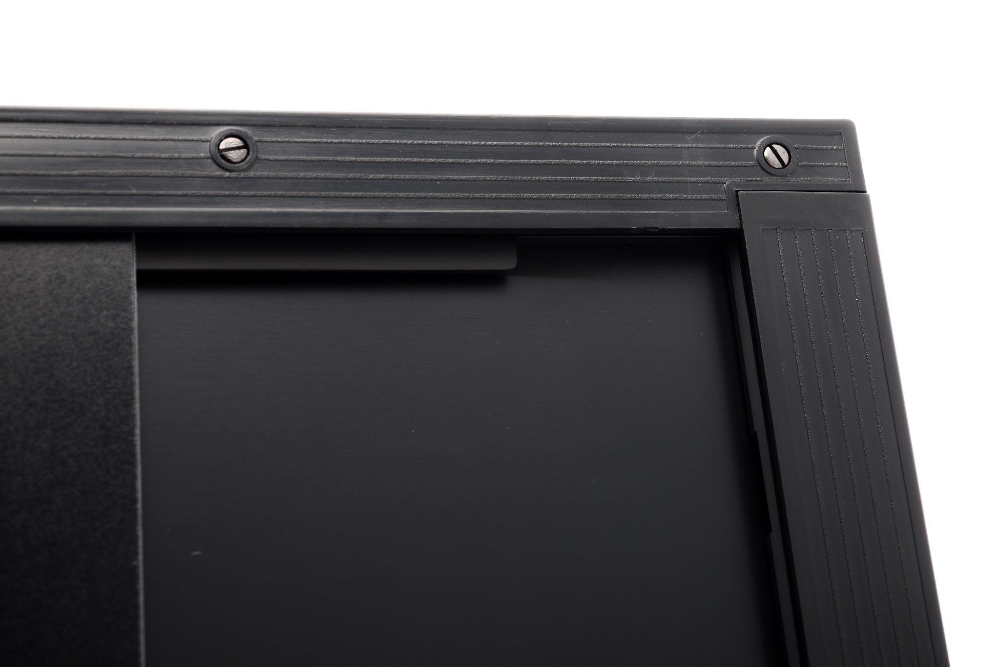 A close-up of a film holder on a white background. Toyo 8x10".