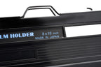 A close-up of a film holder on a white background. Toyo 8x10".