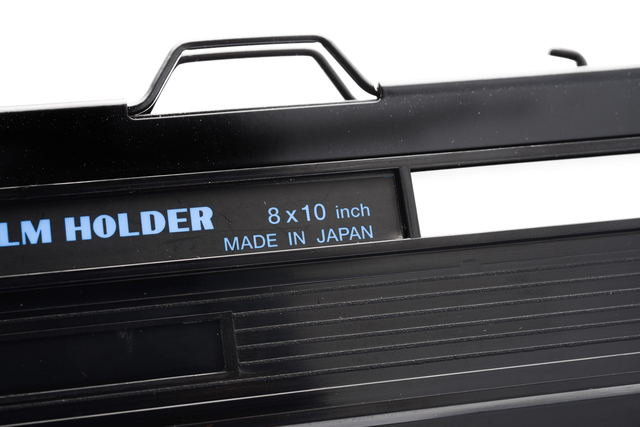 A close-up of a film holder on a white background. Toyo 8x10".